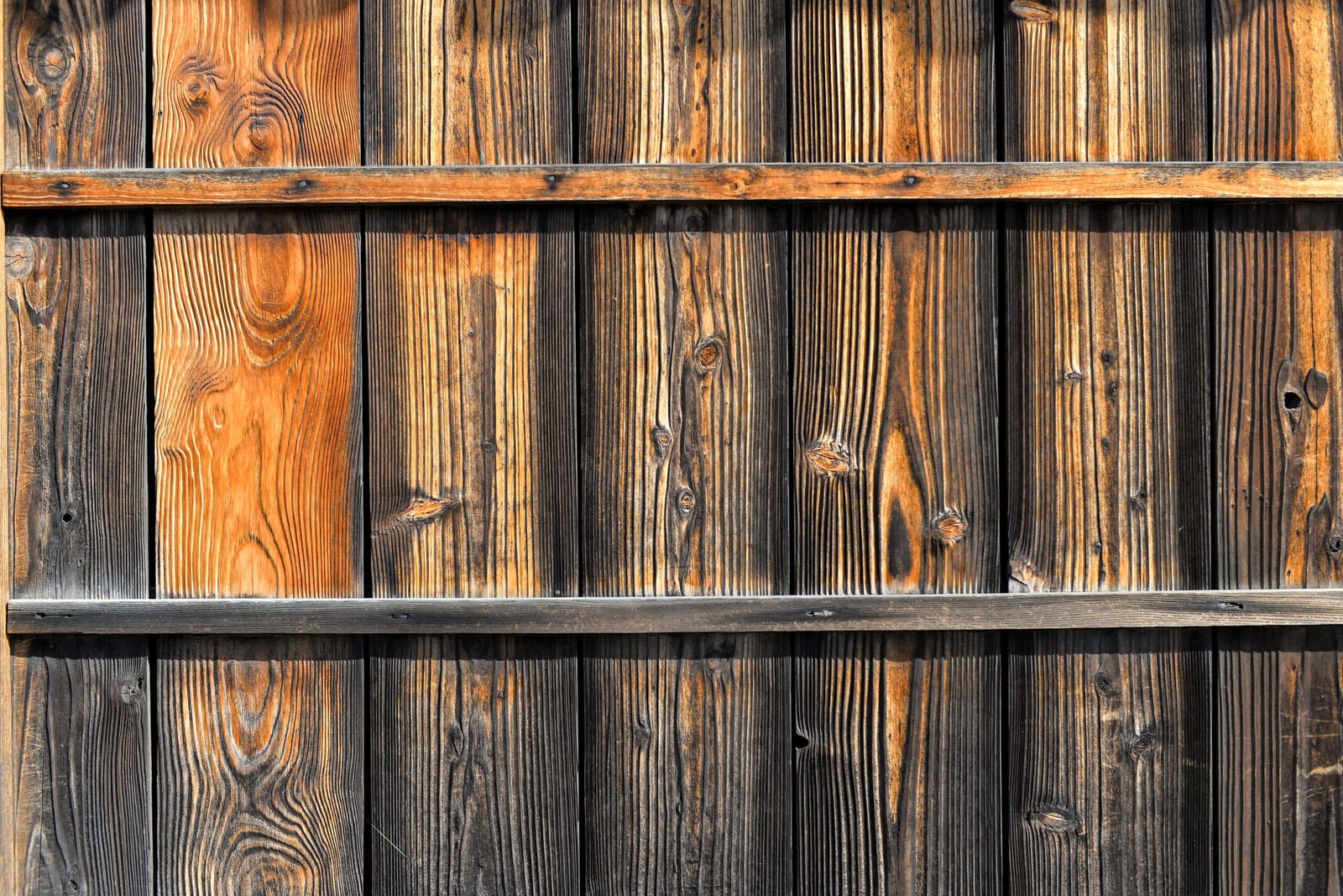 Close-up of rustic wooden fence panels showing natural grain and weathered texture